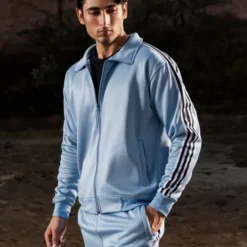 A front view of the 4 Stripes Premium Unisex Tracksuit, featuring a sleek design with four bold stripes on the sleeves and pant legs.