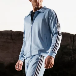 Side view of the 4 Stripes Premium Unisex Tracksuit in [color], showcasing sleek design, comfortable fit, and signature four-stripe detailing on the sleeve and pants.