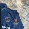Close-up left side view of the BMW Sauber Navy Jacket, showcasing the detailed stitching and embroidered logo.