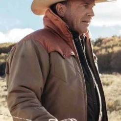 Side profile of Kevin Costner in the Yellowstone John Dutton jacket, showcasing its sturdy design and classic cowboy appeal.
