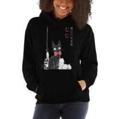 Black hoodie featuring Jiji, the black cat from Kiki’s Delivery Service, sitting with a red bow tie alongside two white kittens and a broomstick, with Japanese text.