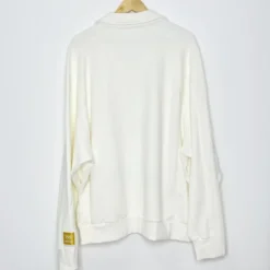 Kith Olympics Heritage Nelson Collared Pullover back view in off-white with a clean, minimalist design and a gold Olympic patch on the sleeve.