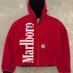Vintage red Marlboro Carhartt jacket with a hood, zip-up front, ribbed cuffs, and bold white Marlboro branding on the left side.