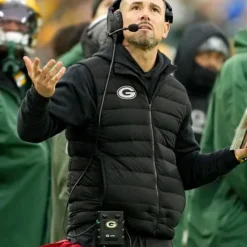 Black puffer vest inspired by Matt LaFleur, featuring a zip-up front and a sporty design.
