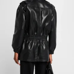 Back view of a black faux leather parka with a gathered waist and relaxed fit, worn by a model against a neutral background.