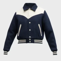 A close-up of the Mother The Western Varsity Jacket, showcasing its navy blue wool blend fabric, cream-colored yoke, and button-up front.
