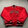NBA 90s Chicago Bulls red satin bomber jacket with button closure and embroidered team logo.