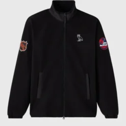 NHL Winnipeg Jets Coach’s Jacket Front View – Black zip-up jacket with embroidered OVO owl logo and team patches on sleeves.