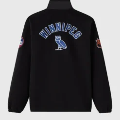 NHL Winnipeg Jets Coach’s Jacket Back View – Black jacket with ‘WINNIPEG’ lettering, OVO owl logo, and team patches on sleeves.