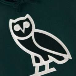 Close-up of the OVO owl logo on the Dark Green OG Hoodie, showcasing textured embroidery details.