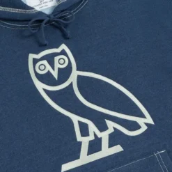Close-up of the OVO owl logo on the Indigo-Dyed Hoodie.