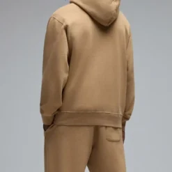 Back view of the OVO Pom Pom Hoodie in tan, showing the relaxed fit and hooded design.