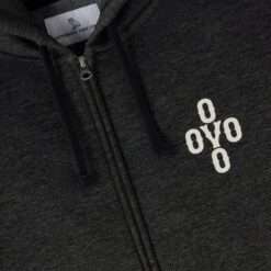 Close-up of the embroidered OVO logo on the Pom Pom Speckle Hoodie in black.