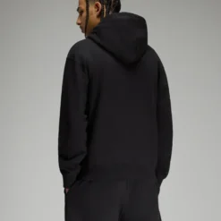 Back view of the black OVO Sports Script Hoodie, showcasing a minimalistic design with a hood.