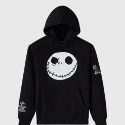 A black hoodie featuring a large embroidered Jack Skellington face on the front, with OVO’s owl logo on the sleeve and The Nightmare Before Christmas branding.