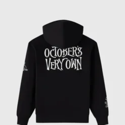 The back of a black hoodie with bold “October’s Very Own” gothic-style text in white.