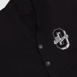 Close-up of the embroidered "O" patch with "October’s Very Own" text on the OVO Varsity Cardigan.