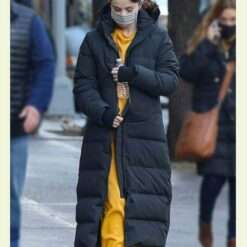 Selena Gomez wearing a long black puffer coat while walking on the set of Only Murders in the Building.