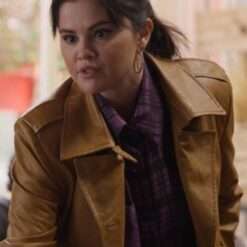 Close-up view of Selena Gomez in a brown leather trench coat from Only Murders in the Building Season 3, highlighting the collar and lapel details.