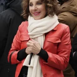 Joy from Only Murders in the Building Season 2 wearing a vibrant red leather jacket with a fitted design and buttoned front.
