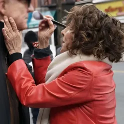 Side profile of Joy in Only Murders in the Building Season 2, showcasing the sleek cut and stylish details of her red leather jacket.