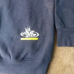 A close-up of the PNB Nation logo printed on the lower sleeve of the navy blue hoodie.