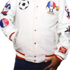 Paris 2024 France Olympics Wool Varsity Jacket front view, featuring multiple embroidered patches including a soccer ball, Olympic rings, and a French flag mascot.