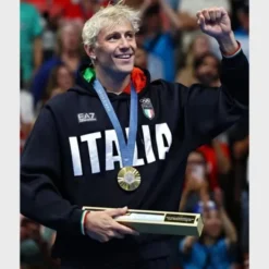 Paris 2024 Olympics Italia Black Hoodie featuring bold "ITALIA" lettering, Italian flag emblem, and EA7 branding.