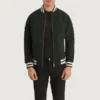 Pascal Green Suede Varsity Jacket front view, featuring a zip-up closure and striped ribbed collar, cuffs, and hem.