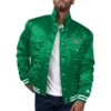 Front view of the Philadelphia Eagles Silver Tab Trucker Jacket in shiny green satin, featuring an embroidered Eagles logo and button-up closure.