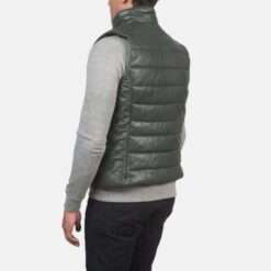 A model wearing the Reeves Leather Puffer Vest in deep green, shown from the back with a quilted design and a high collar.