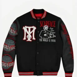 A black varsity jacket featuring red and white accents, Scarface-themed embroidery, and patches with the phrase "The World is Yours.