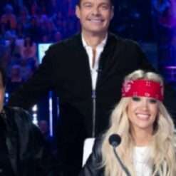 Ryan Seacrest on American Idol Season 23 dons a suede bomber jacket, combining sleek sophistication with a touch of casual style, perfect for his on-stage presence.