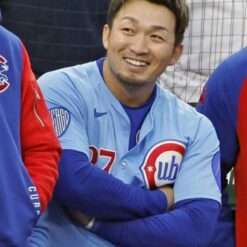 Seiya Suzuki of the Chicago Cubs wears a Phillies vs. Cubs jersey, showcasing the team’s traditional design with bold lettering and team logo, as he steps up to the plate during the game.