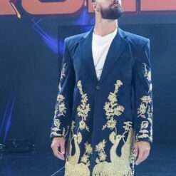 Seth Rollins wears a black floral coat at WWE Monday Night Raw in Kansas City, featuring intricate floral embroidery on a sleek black fabric, blending bold style with sophistication for his iconic ring entrance.