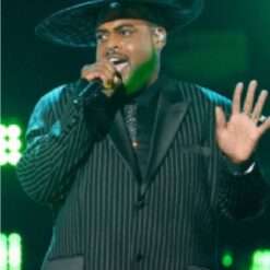 Darius J on The Voice Season 27 wears a sleek pinstriped blazer, combining classic tailoring with a modern twist for a sophisticated and sharp look.