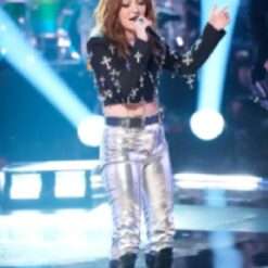Iris Herrera on The Voice Season 27 stuns in a cropped silver crosses blazer, featuring metallic accents and a bold, tailored fit that adds a striking, edgy flair to her performance look.
