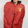 NFL Sideline Cape Coat featuring a weather-resistant outer shell, oversized fit with a hood, team logo on the chest, and snap-button front for easy wear on game days.