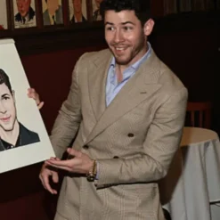 Nick Jonas at Sardi’s portrait unveiling wearing a checked blazer – tailored fit with subtle plaid pattern and classic lapels.