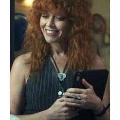 Natasha Lyonne in Poker Face wearing a pinstripe denim vest – sleeveless with vertical pinstripes and a casual, edgy look.
