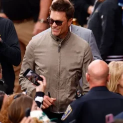 Brown jacket worn by Tom Brady at the 109th Running of the Indianapolis 500, featuring a sleek design, front zipper closure, and a sporty, refined look.
