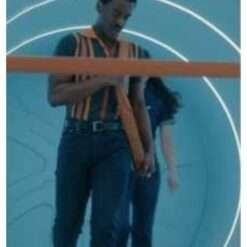 Ncuti Gatwa wearing a tri-color striped polo shirt from Doctor Who Season 15 – stylish men's shirt featuring horizontal stripes in three colors, a classic collar, and short sleeves.